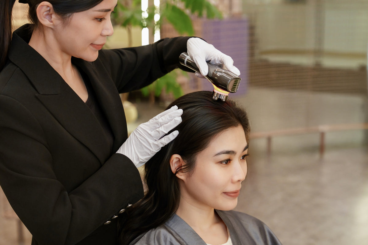 A TrichoLab specialist applying an ampoule to a client’s scalp