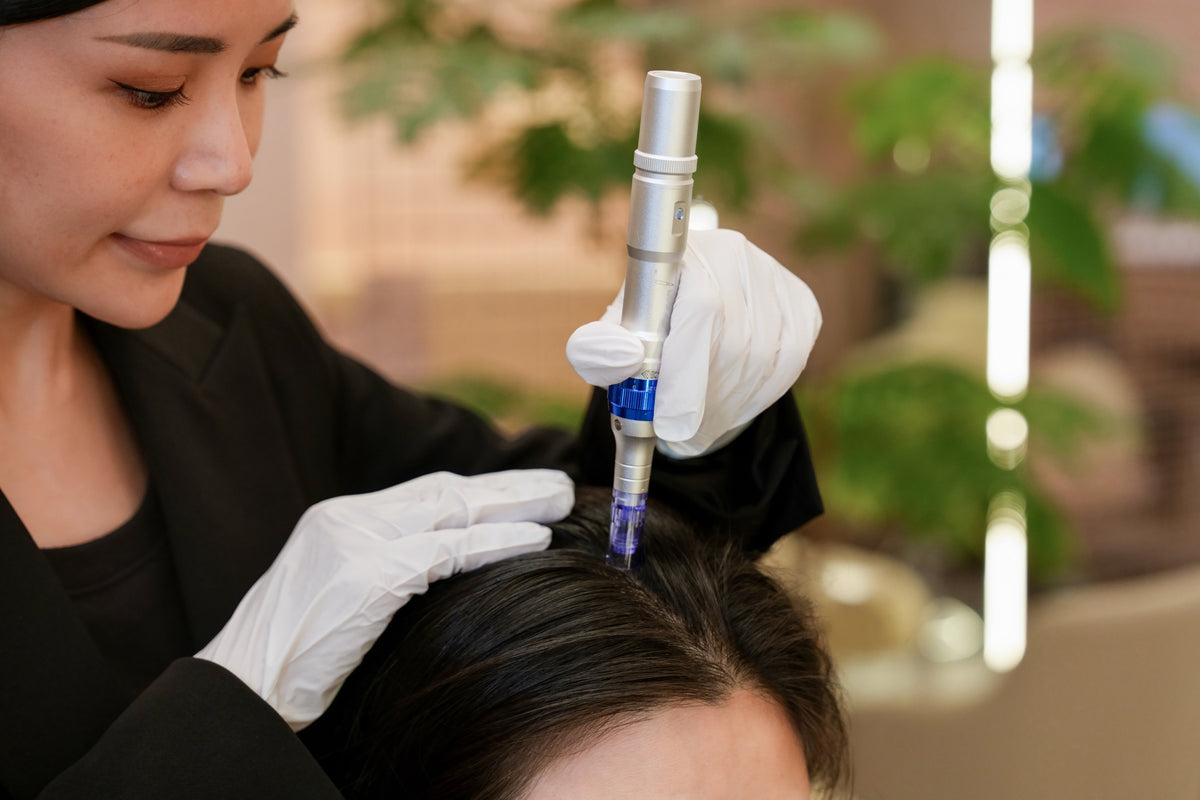 A TrichoLab specialist performing medical microneedling on a client’s scalp