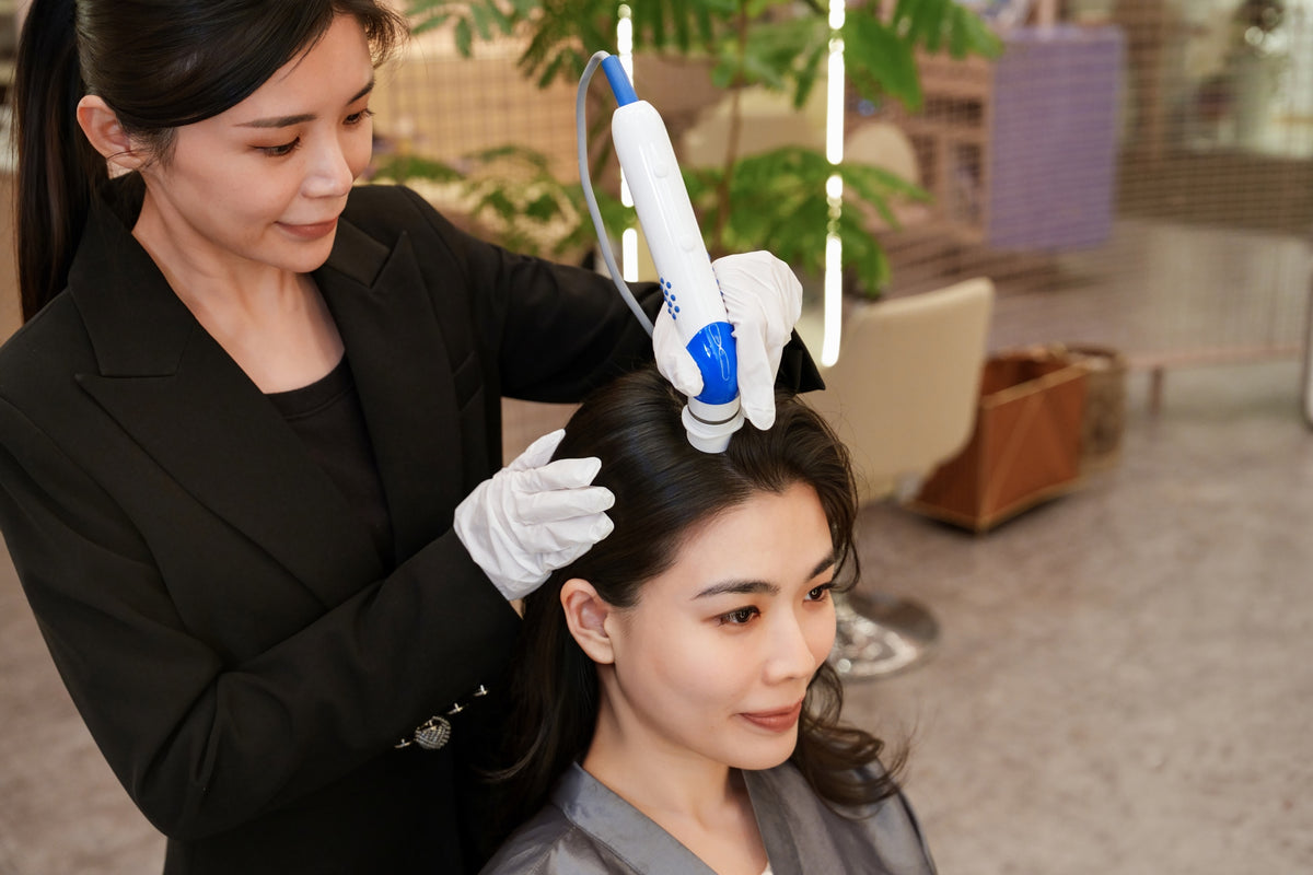 A TrichoLab specialist treating a client’s scalp with the DEP ES Neo handpiece