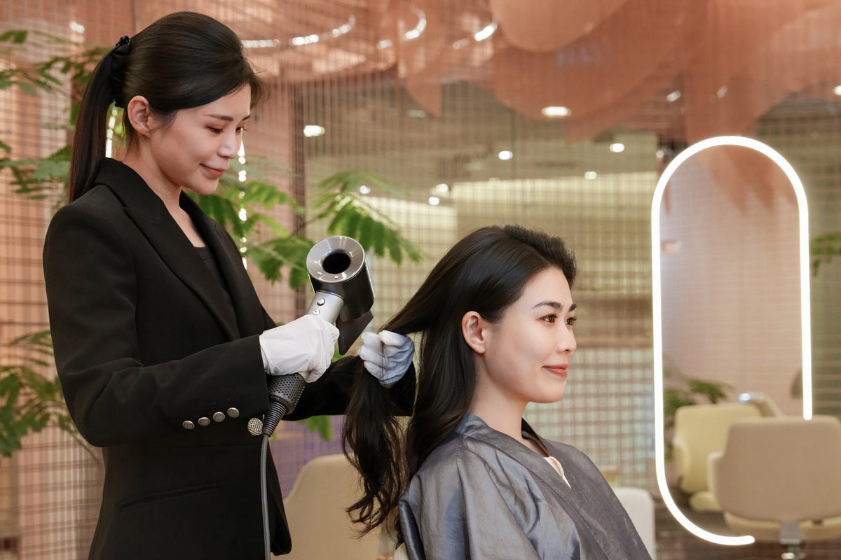 A TrichoLab stylist blow-drying a client's hair after the TrichoSmooth Hair Treatment